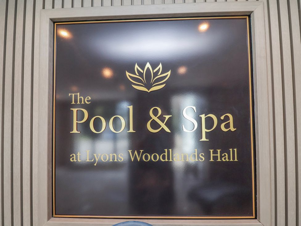 A sign for The Pool & Spa at Lyons Woodlands Hall
