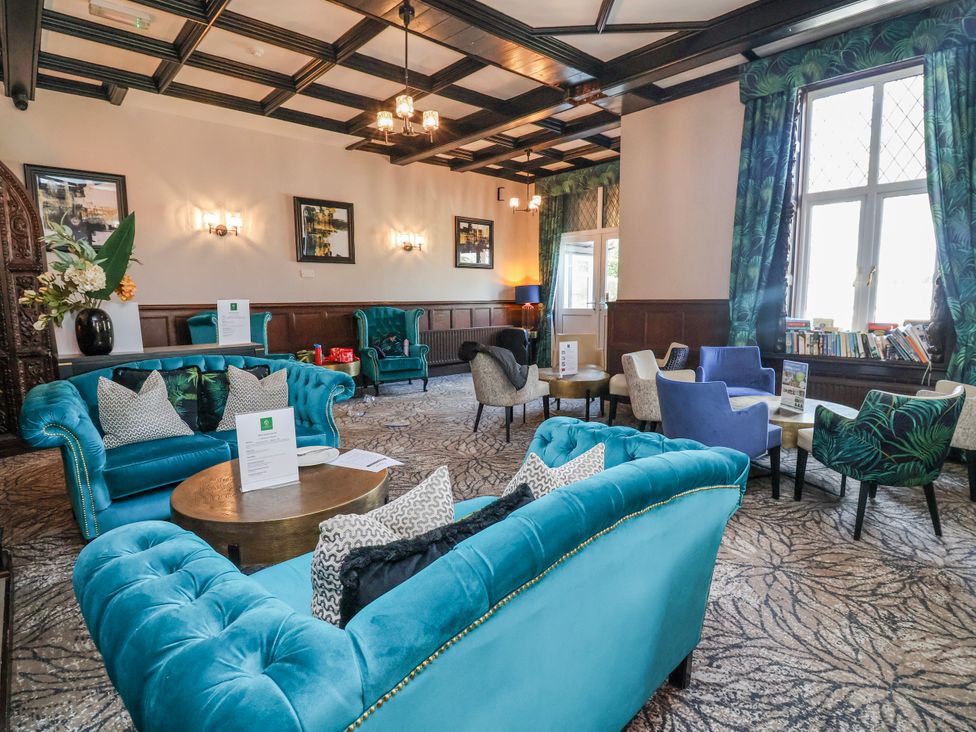 A lounge with sofas and tables at Woodlands Gold (WO 41) Ruthin