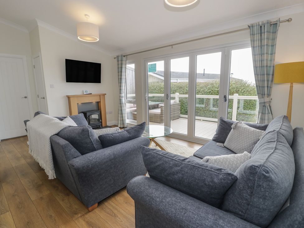 A living room with a television and sofas at Platinum Lodge (503) Talybont