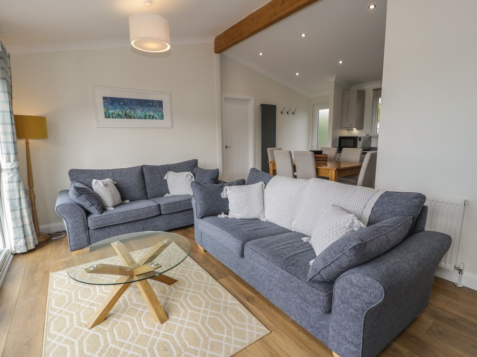 A living room with sofas and a coffee table at Platinum Lodge (503) Talybont