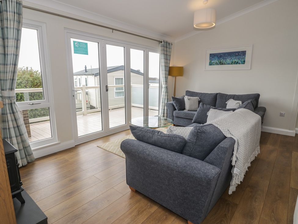 A living room with a sofa and coffee table at Platinum Lodge (503) Talybont