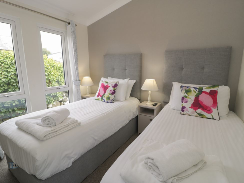 A bedroom with two beds and windows at Platinum Lodge (503) Talybont
