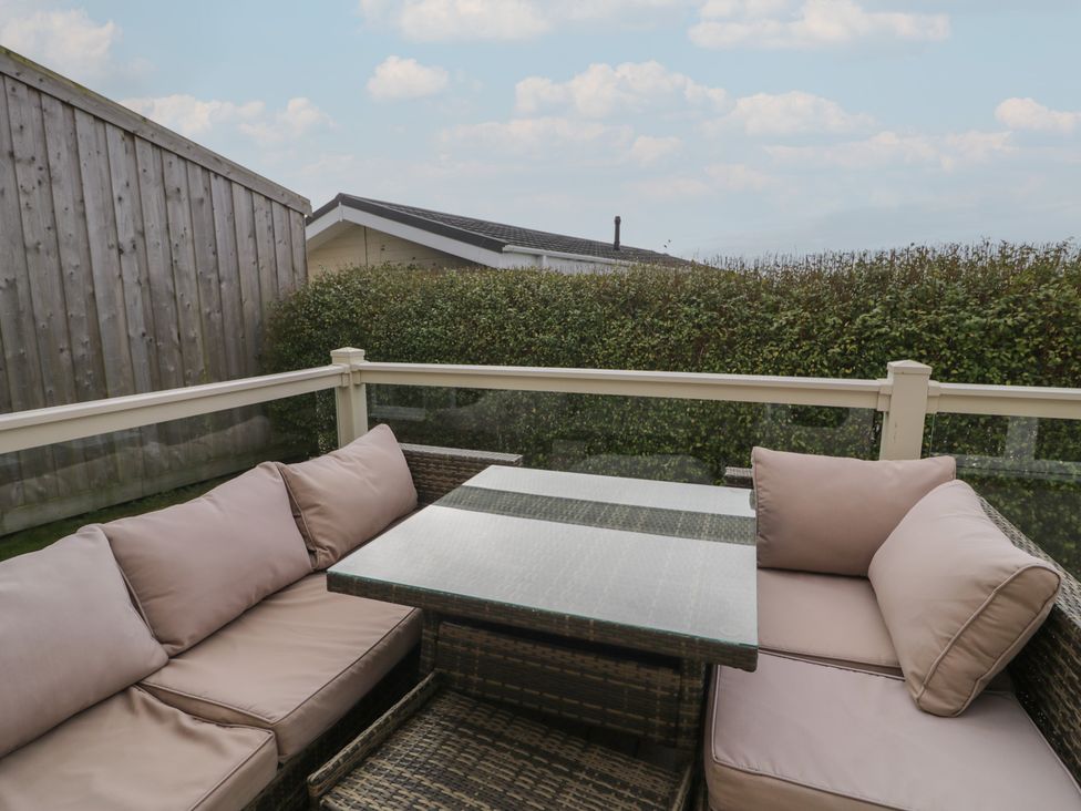 An outdoor seating area with a sofa and table at Platinum Lodge (503) Talybont