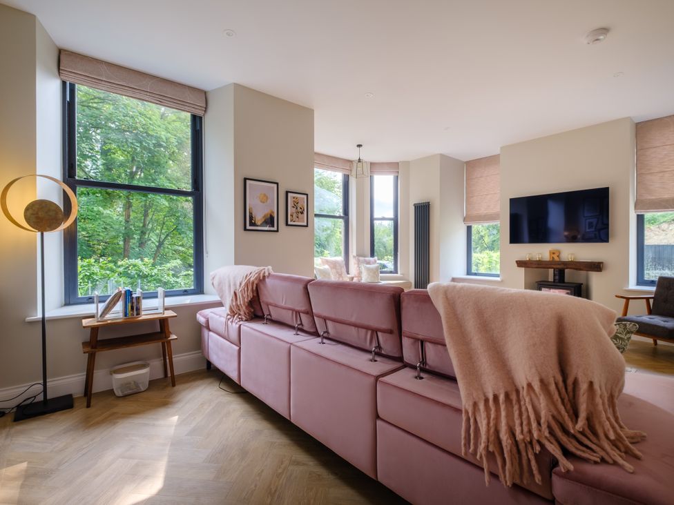 A living room with a sofa and television at Riverside in Ambleside