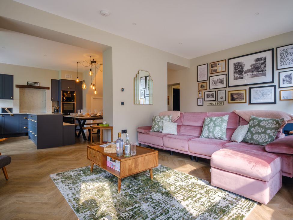 A living room with a pink sofa and coffee table at Riverside in Ambleside