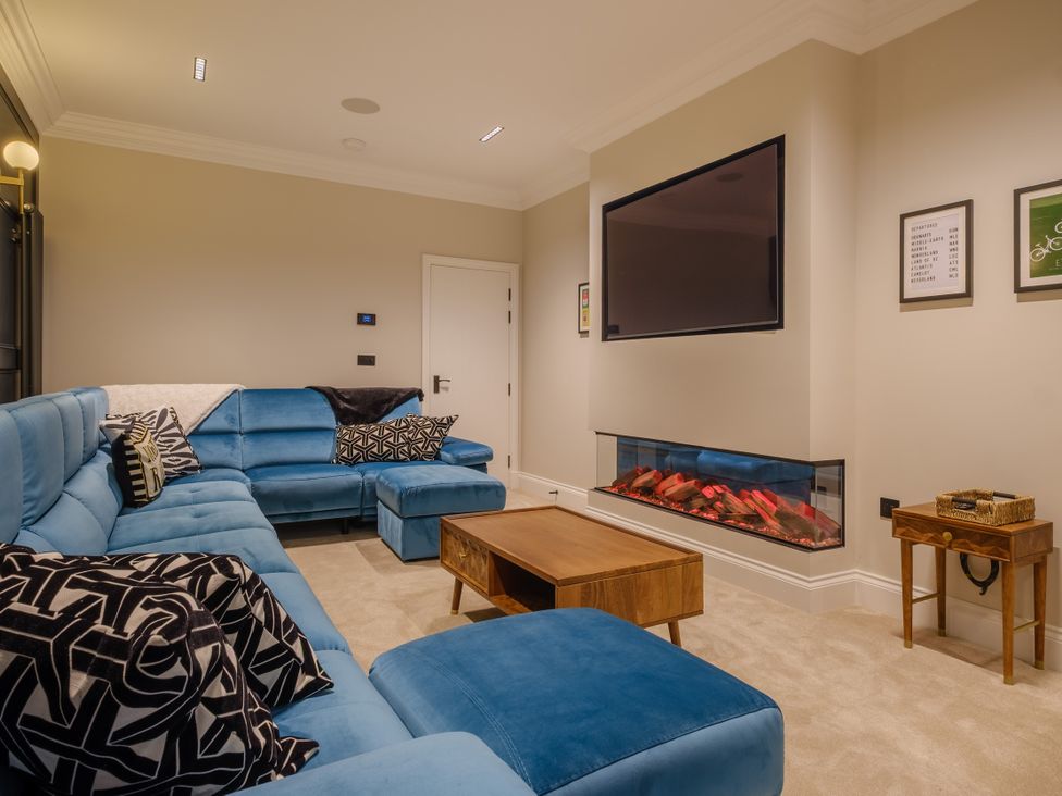 A living room with a sofa and television at Riverside in Ambleside