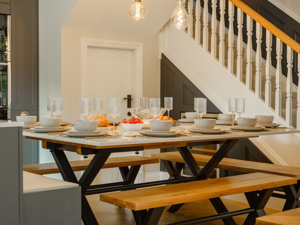 A dining room with a table set for a meal at Riverside in Ambleside