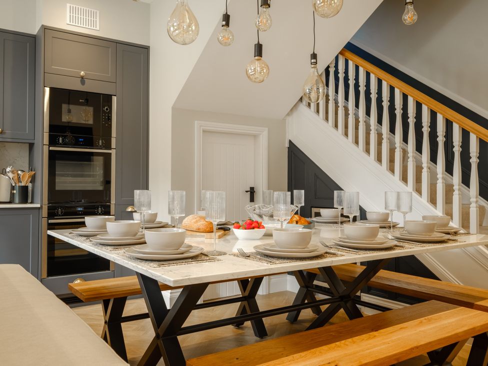 A dining room with a table set for meals at Riverside in Ambleside