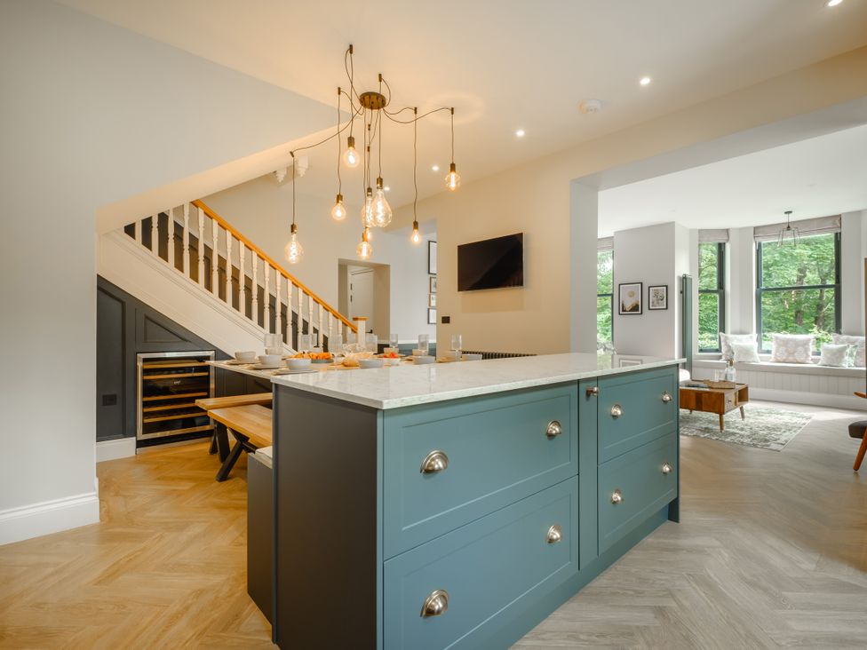 A kitchen with a central island and pendant lighting at Riverside in Ambleside