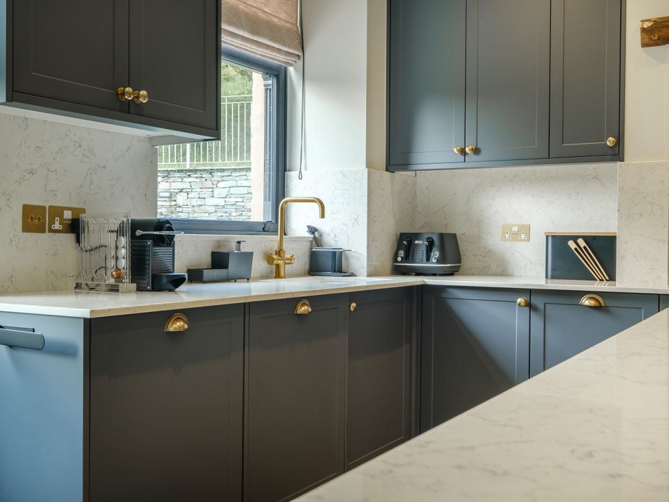A kitchen with cabinets and appliances at Riverside in Ambleside