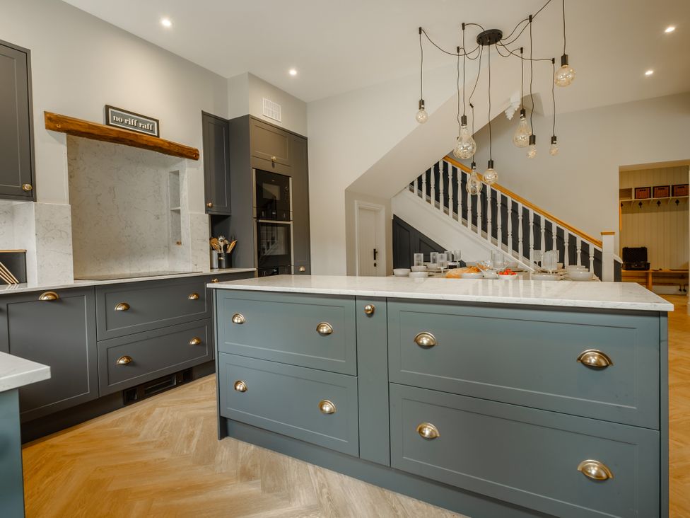 A kitchen with cabinets and a marble countertop at Riverside in Ambleside