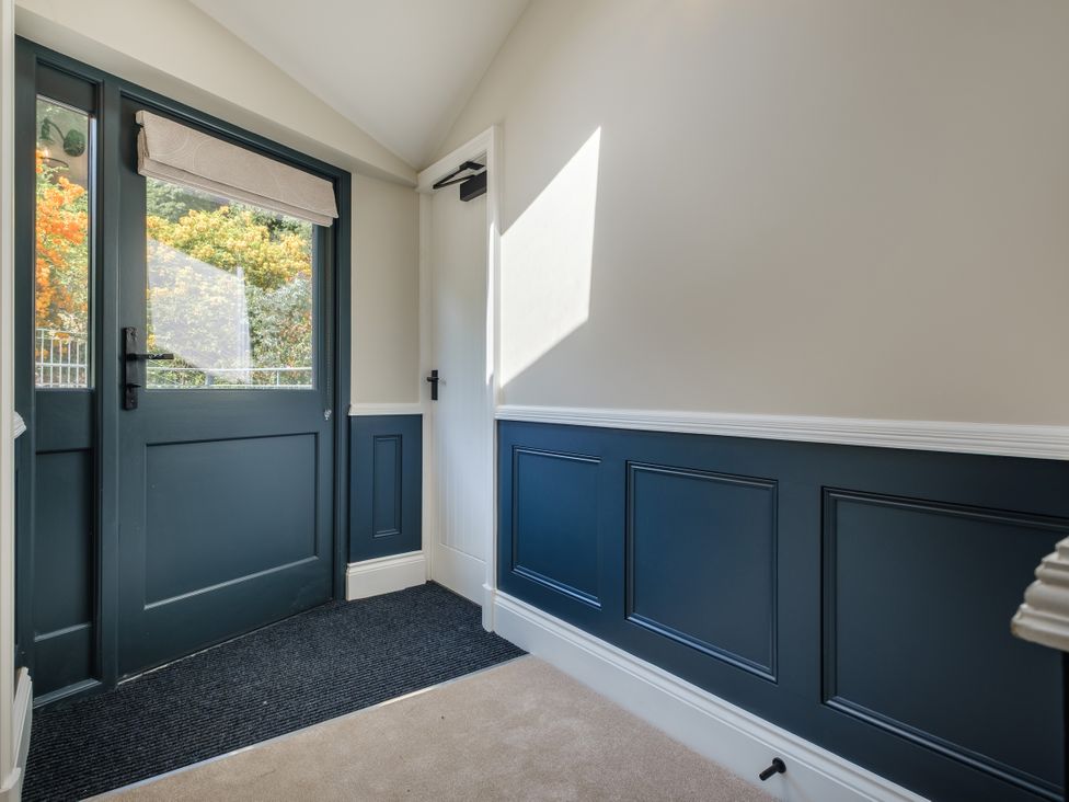 An entrance hall with a door and window at Riverside in Ambleside