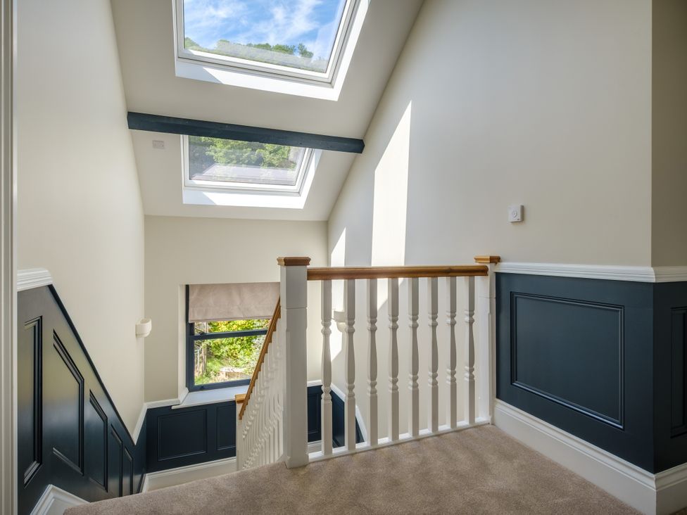 A hallway with a staircase and skylight at Riverside in Ambleside
