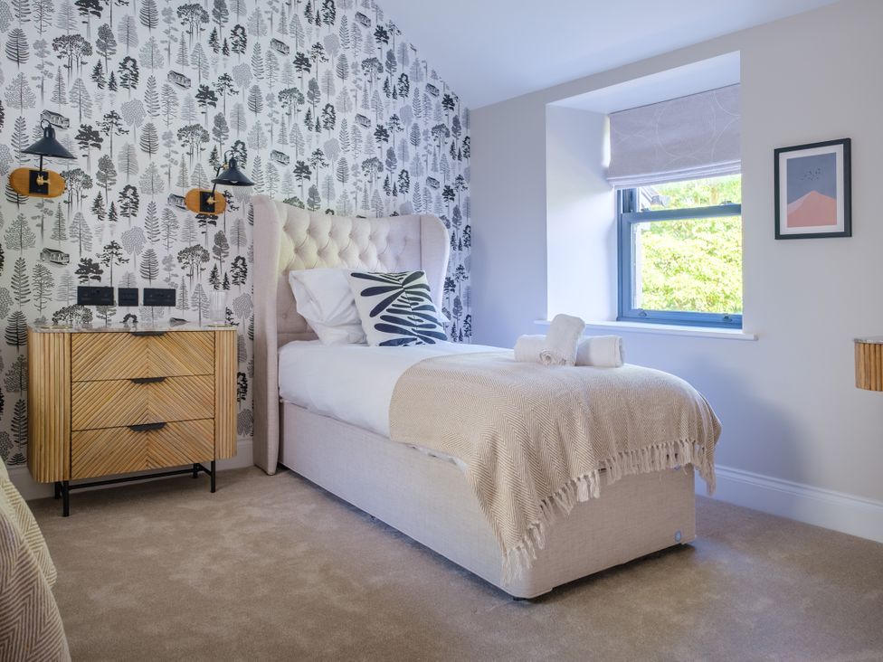 A bedroom with a bed and nightstand at Riverside in Ambleside