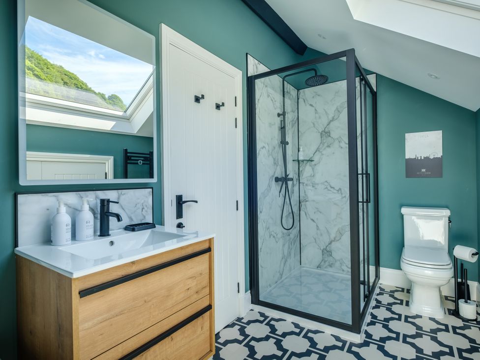 A bathroom with a shower, toilet, and vanity at Riverside in Ambleside