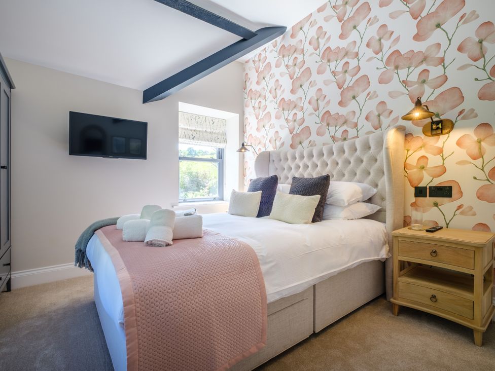 A bedroom with a bed and a TV at Riverside in Ambleside