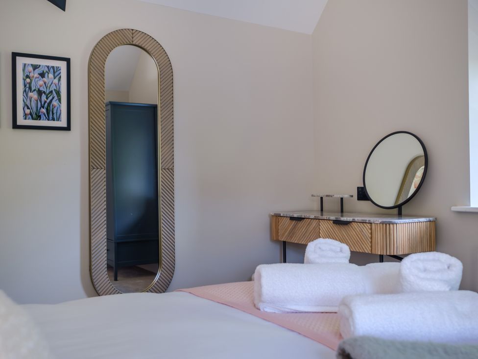 A bedroom with a bed and towels on display at Riverside in Ambleside