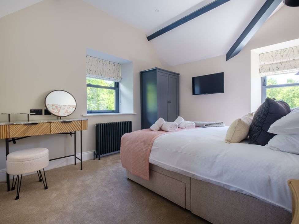 A bedroom with a bed and wardrobe at Riverside in Ambleside