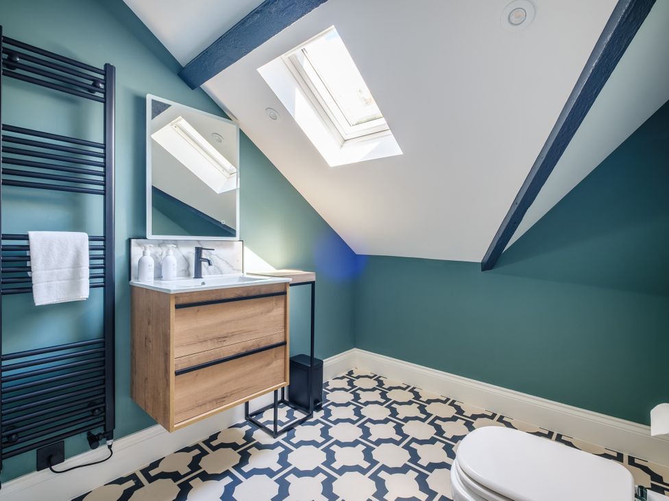 A bathroom with a sink, toilet, and towel rack at Riverside in Ambleside