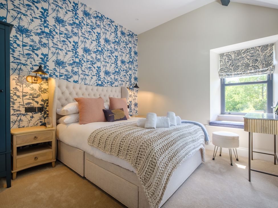 A bedroom with a bed and nightstand at Riverside in Ambleside