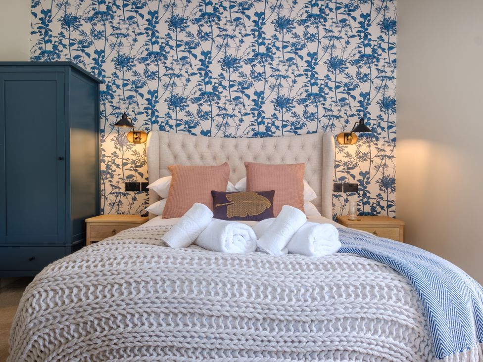A bedroom with a bed and wardrobe at Riverside in Ambleside