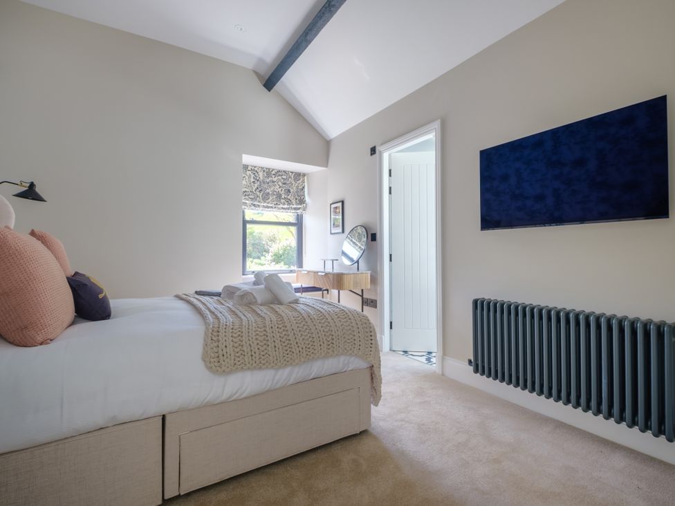 A bedroom with a bed and television at Riverside in Ambleside