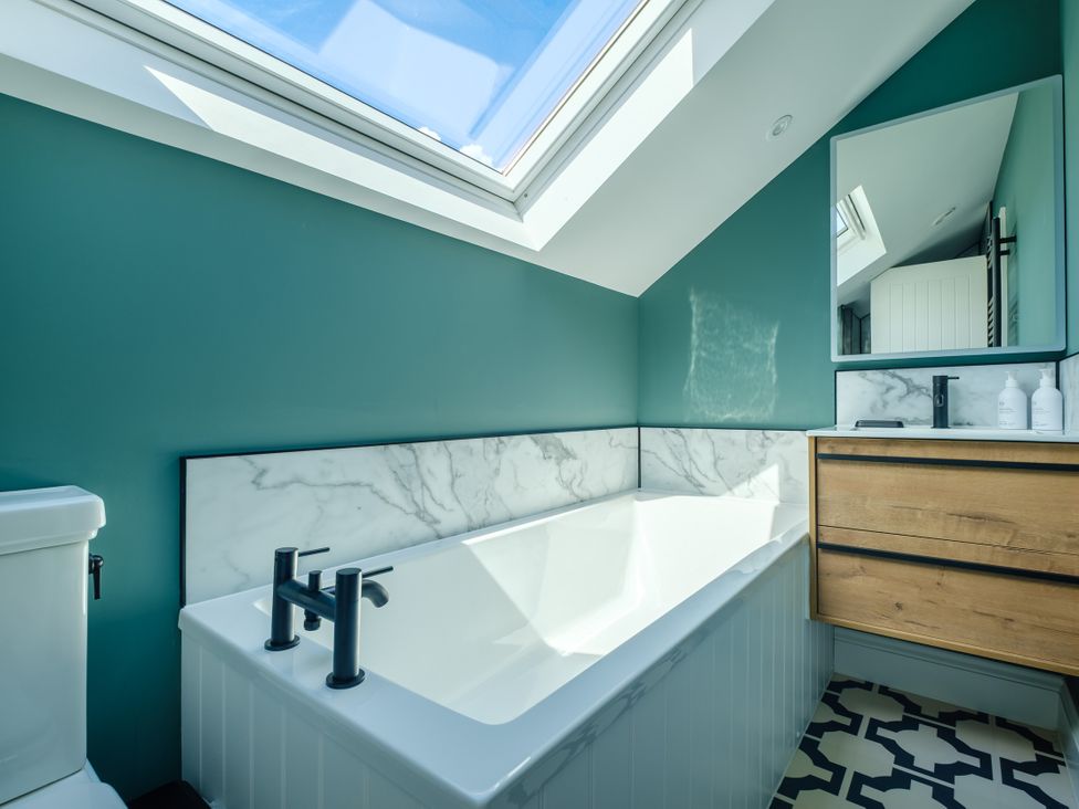 A bathroom with a bathtub and sink at Riverside in Ambleside