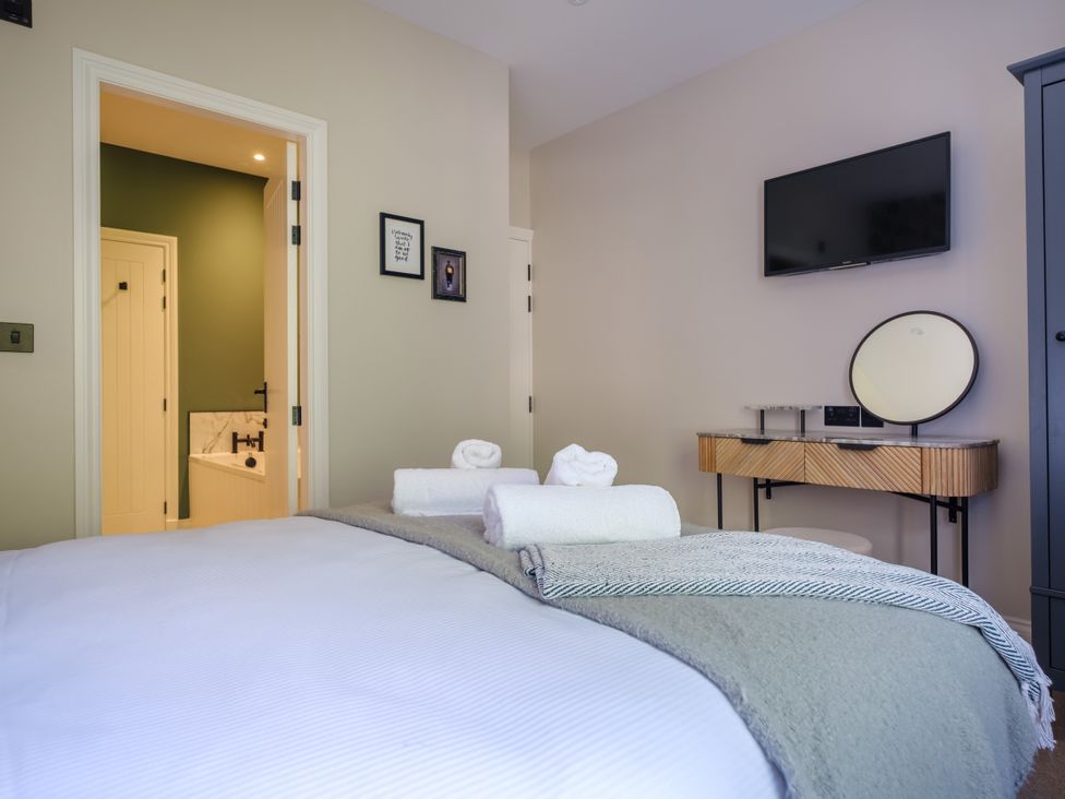 A bedroom with a bed and television at Riverside in Ambleside
