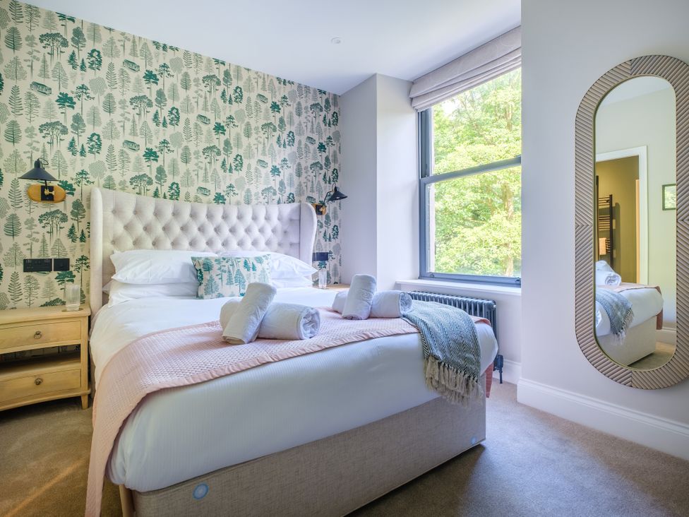 A bedroom with a bed and nightstand at Riverside in Ambleside