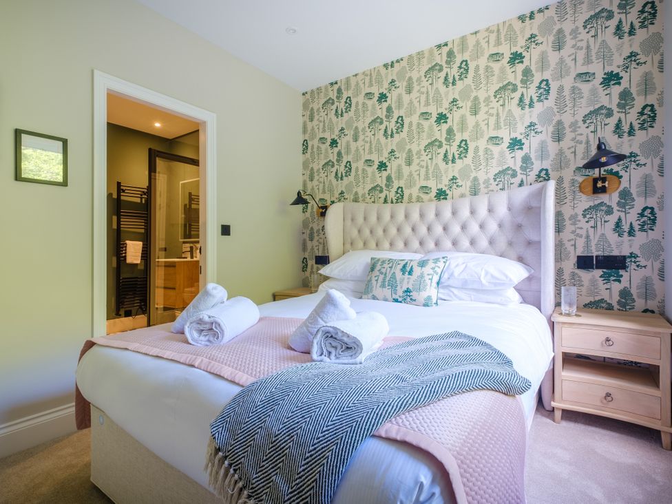 A bedroom with a bed and bedside table at Riverside in Ambleside