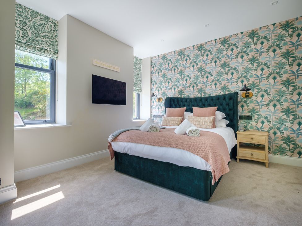 A bedroom with a double bed and television at Riverside in Ambleside