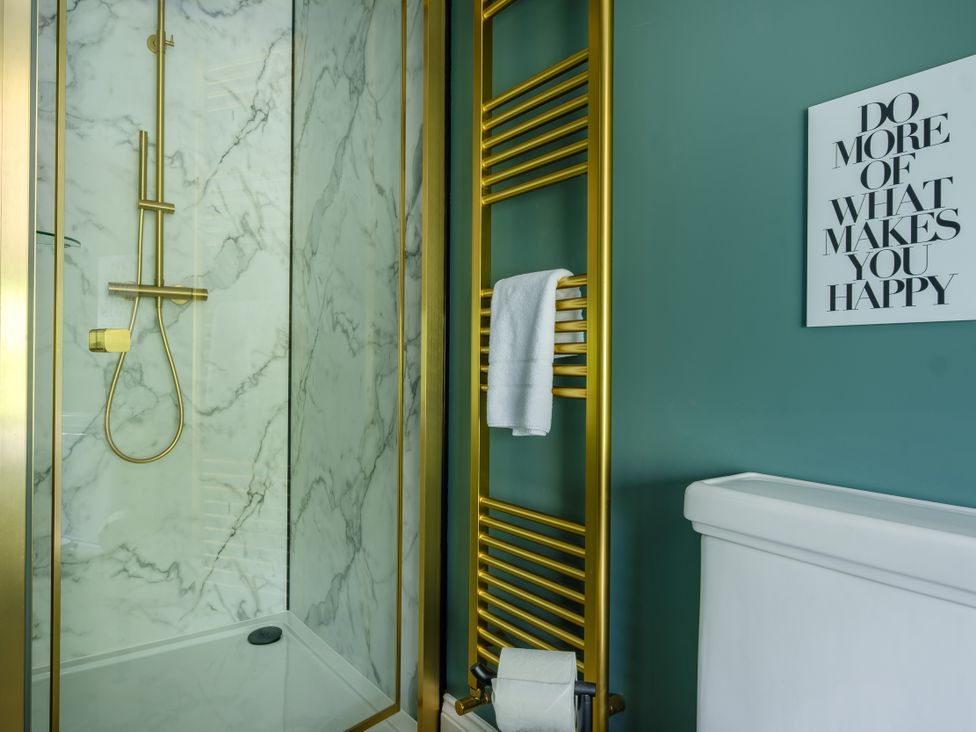 A bathroom with a shower and a towel rack at Riverside in Ambleside
