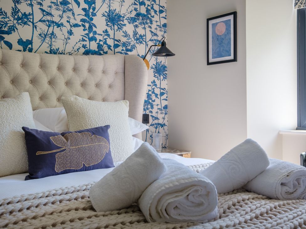 A bedroom with a bed and decorative pillows at Riverside in Ambleside