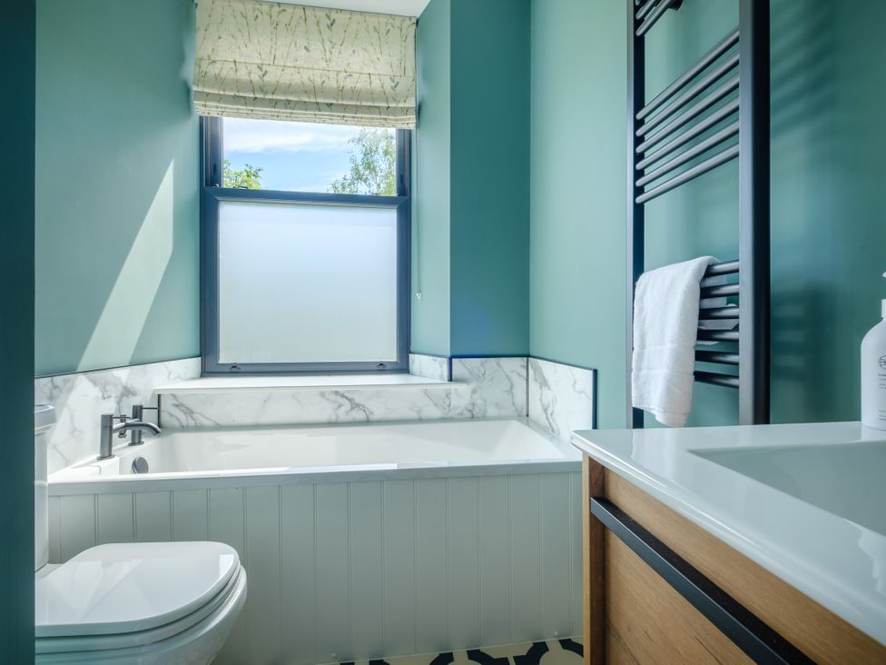 A bathroom with a bath tub and sink at Riverside in Ambleside