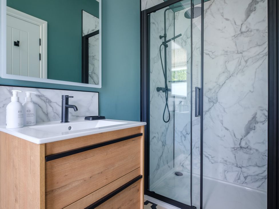 A bathroom with a shower and vanity at Riverside in Ambleside