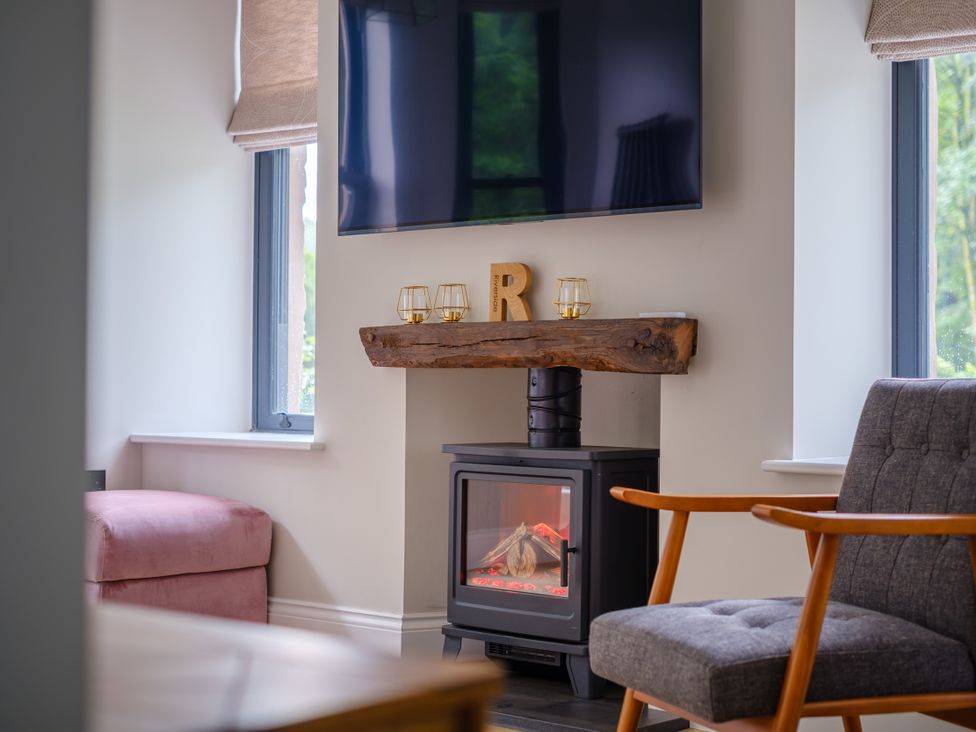 A living room with a television and fireplace at Riverside in Ambleside