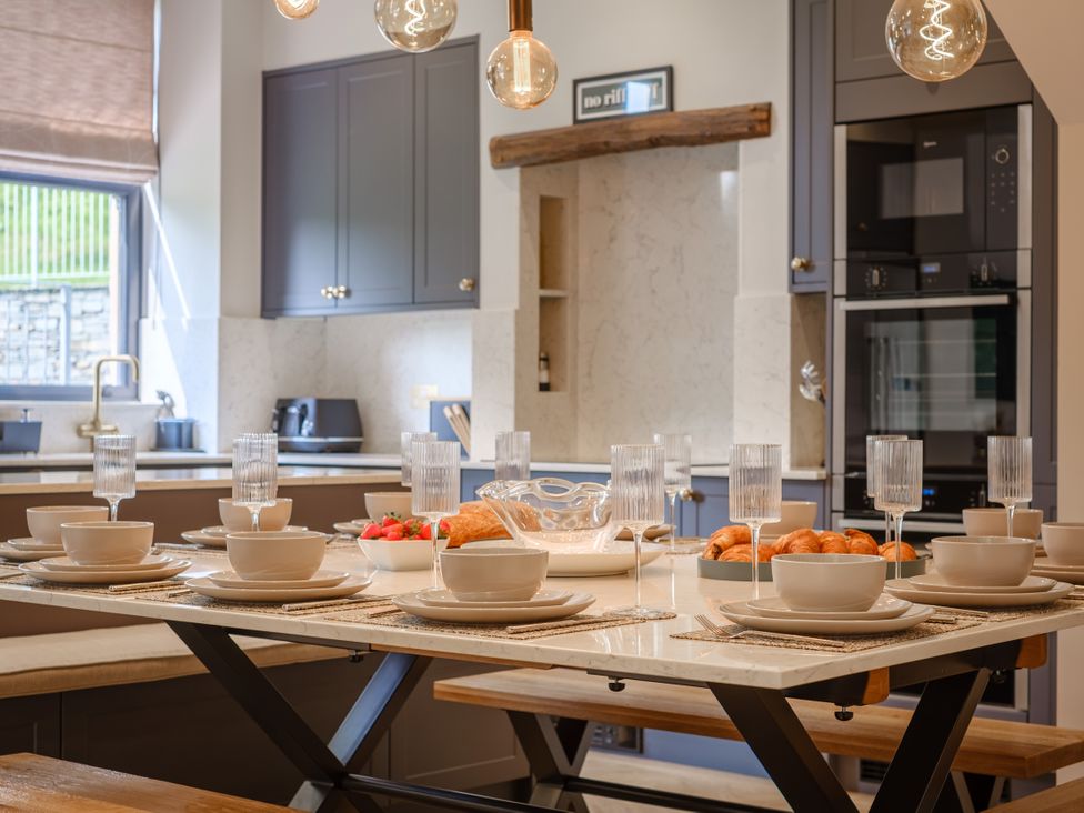 A kitchen with dining table set at Riverside in Ambleside
