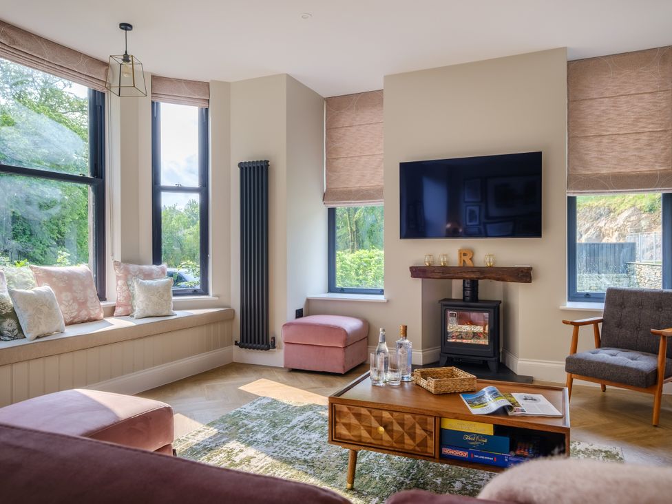 A living room with a sofa and television at Riverside in Ambleside