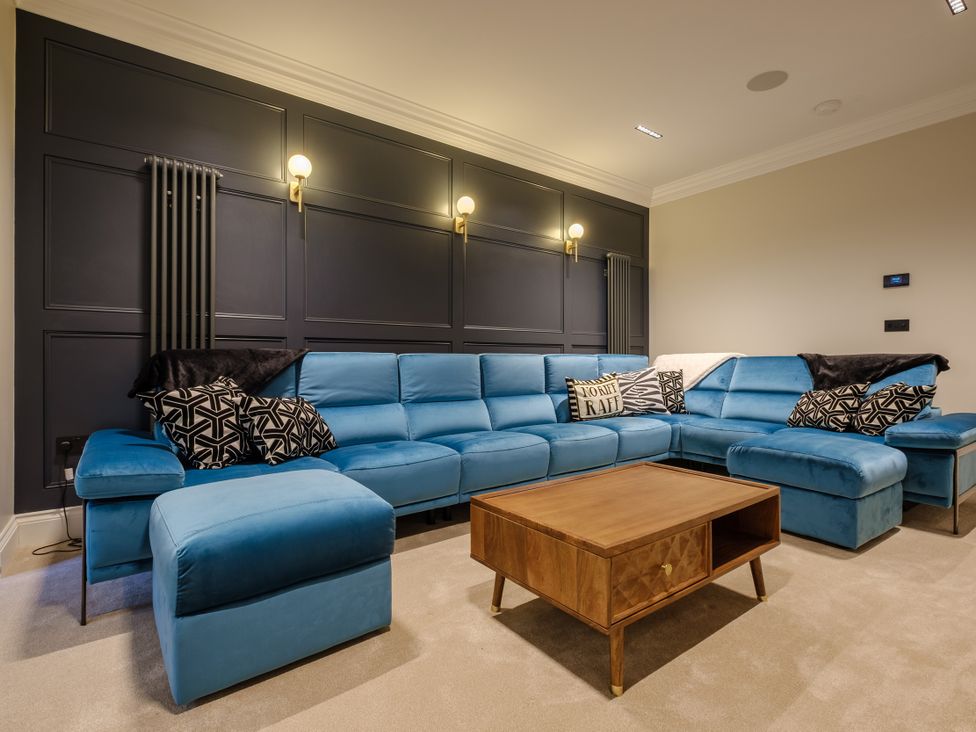 A living room with a blue sofa and coffee table at Riverside in Ambleside