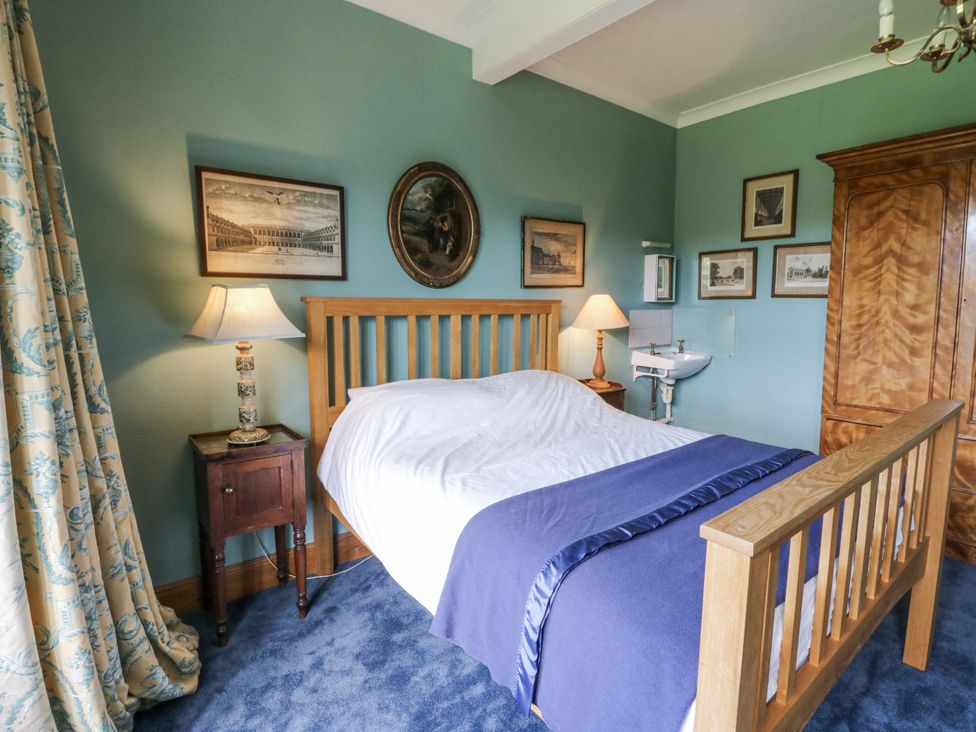 A bedroom with a bed and bedside table at Plas Pontfaen near Fishguard and Newport, Pembrokeshire