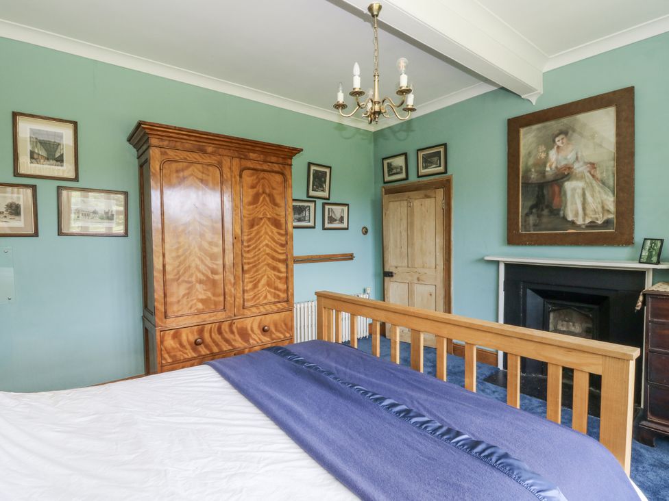A bedroom with a bed and wardrobe at Plas Pontfaen near Fishguard and Newport, Pembrokeshire