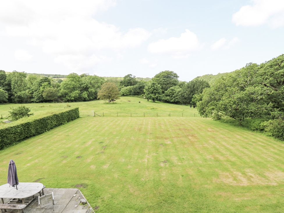 An outdoor area with a table and umbrella at Plas Pontfaen near Fishguard and Newport, Pembrokeshire