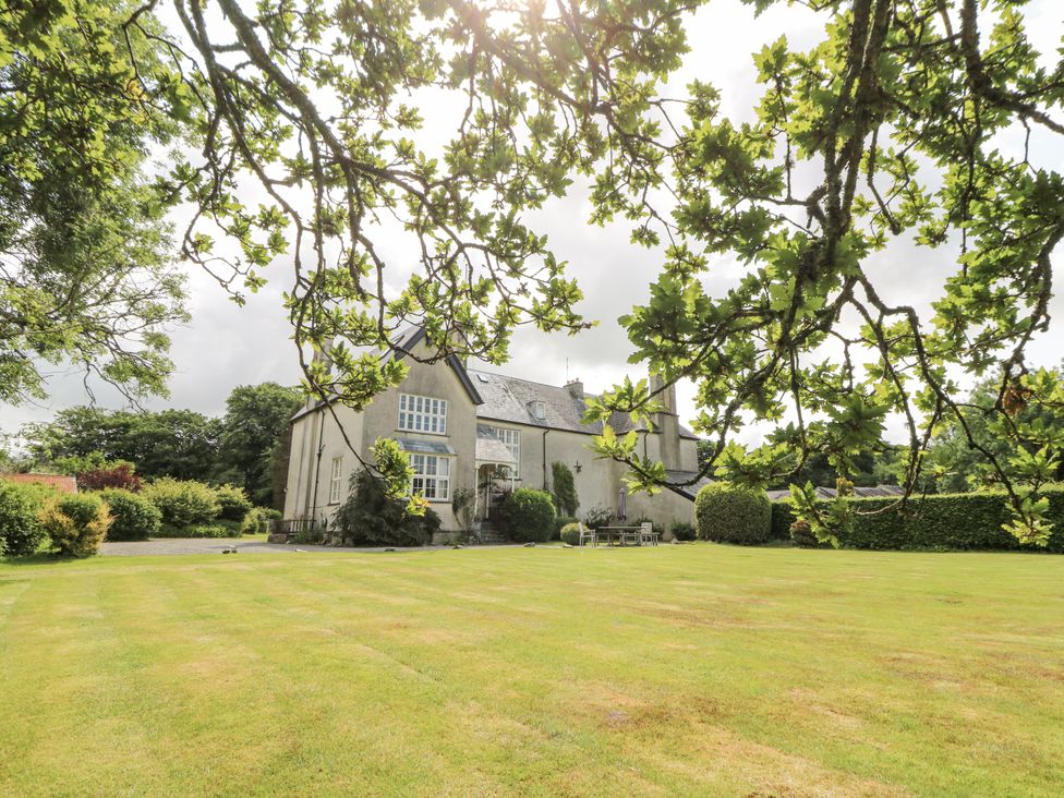 A house and lawn surrounded by trees at Plas Pontfaen near Fishguard and Newport, Pembrokeshire