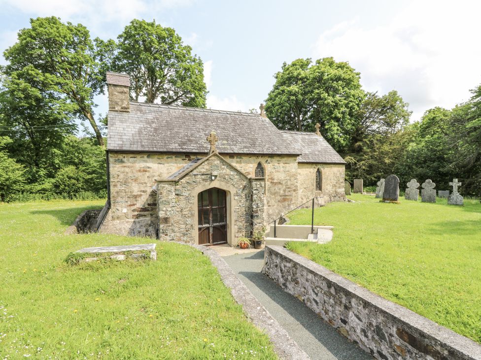 A church with a pathway and gravestones at Plas Pontfaen near Fishguard and Newport, Pembrokeshire