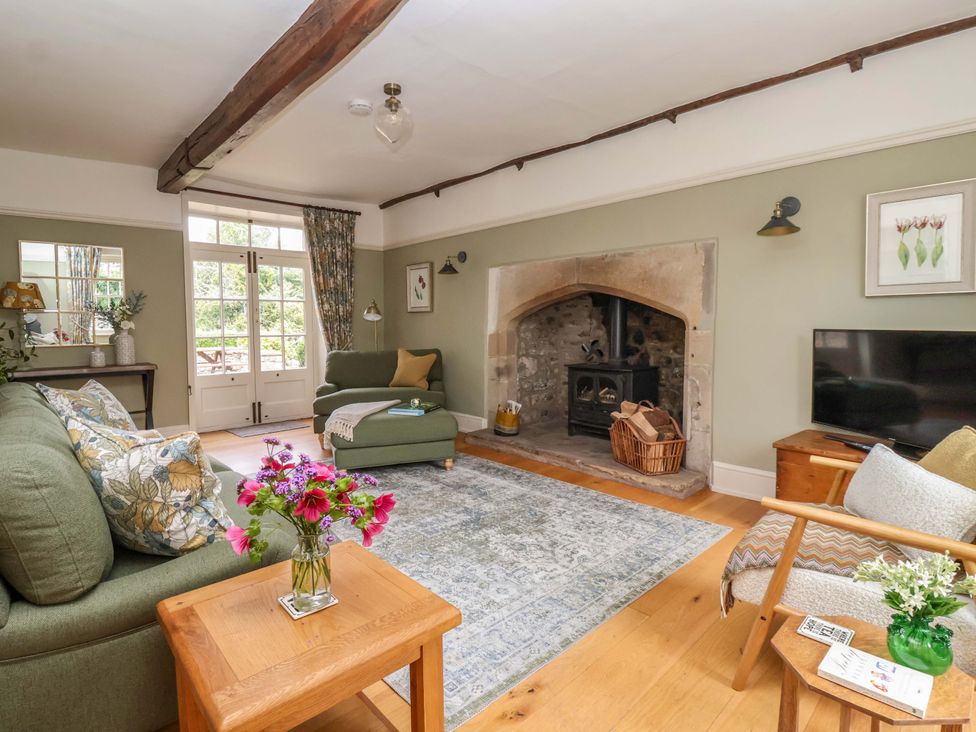 A living room with a fireplace and seating area at Ellis House Skipton