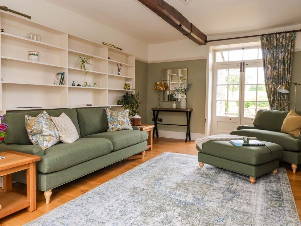 A living room with a sofa and armchair at Ellis House in Skipton