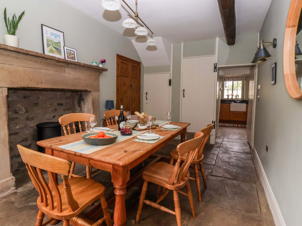 A dining room with a wooden table and chairs at Ellis House in Skipton