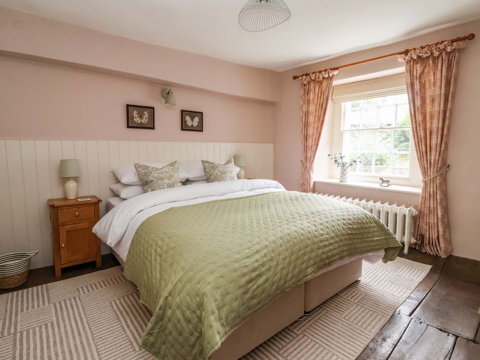 A bedroom with a bed and bedside table at Ellis House in Skipton