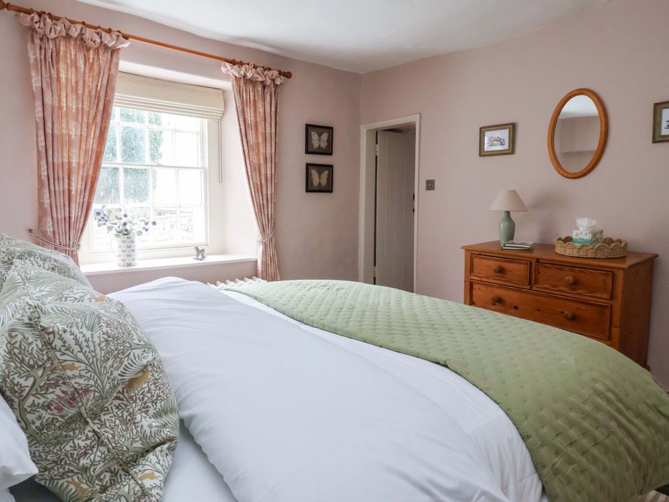 A bedroom with a bed and dresser at Ellis House in Skipton