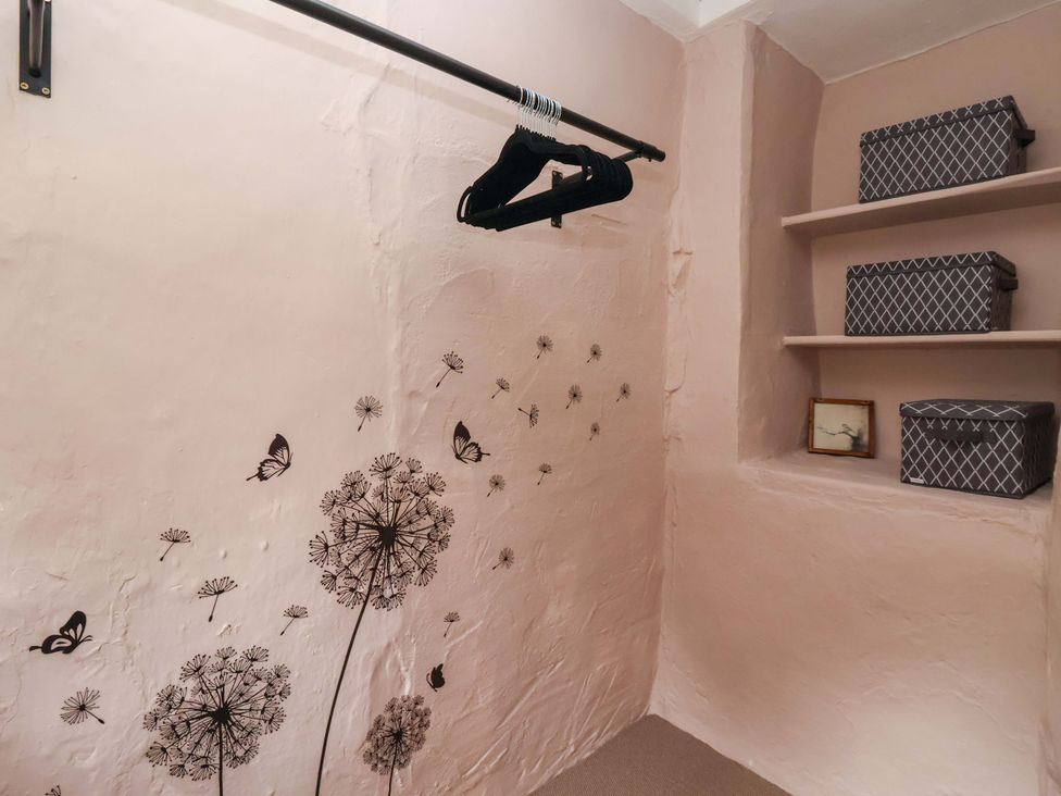 A storage room with shelves and storage boxes at Ellis House in Skipton